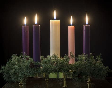Coloured advent candles - Those using a Lenten triad also use six candles. A foam or wood triangle shape is covered with a black cloth. The triad is a symbol of the Holy Trinty - Father, Son and Holy Spirit. The black cloth is a symbol of grief. Two candles are placed in holders on each side of the triangle.